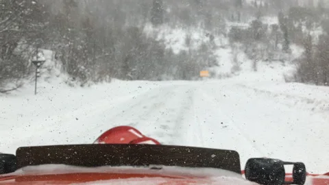 A shot from inside a snow plow on a canyon road during a snow storm in Stock Footage 166444269