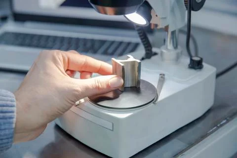 Shot of laboratory microscope with metal sample.. Foto stock