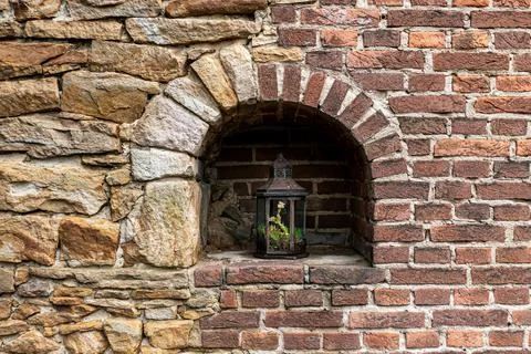 A shot of a lamp inside a frame of a bricky wall in the Grugapark in Essen, G Stock Photos