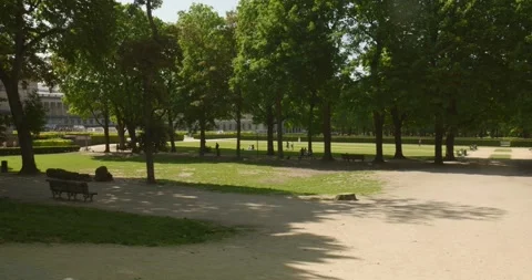 Shot of locals walking along the path in Parc du Cinquantenaire park on a Video stock 243968666