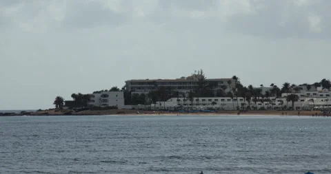 Shot looking across playa de los Pocillos, with hotels in background 動画素材 336723053