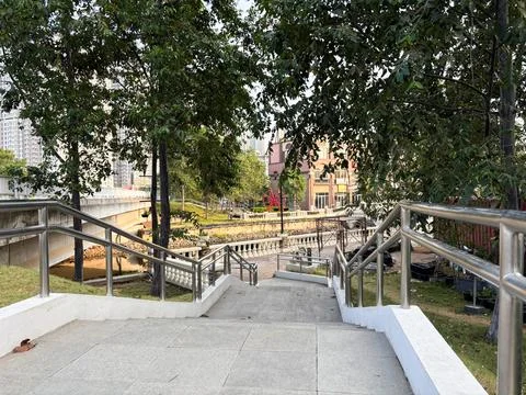 Shot looking down a flight of outdoor stone stairs with stainless steel railings Stock Photos