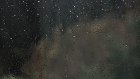 Shot looking through a window at a storm blowing a tree Stock Footage