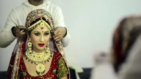 Shot of a make-up man preparing a Indian bride Stock Footage