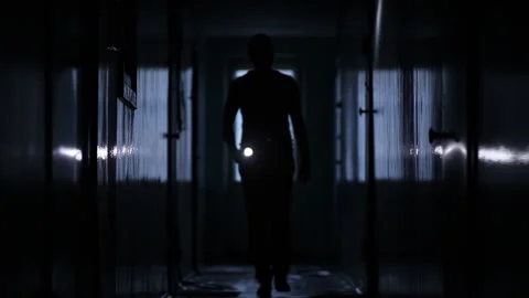 Shot of male inline walking along hostel corridor, static camera Stock Footage 252853972