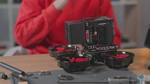 Shot of male student composing elements of drone, making electronic FPV drone Stock Footage 189395136