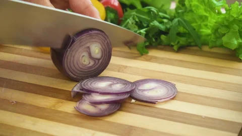 Shot of man chef cutting bow on chopping wooden board Stock Footage 87816356