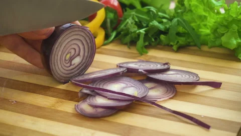 Shot of man chef cutting bow on chopping wooden board Stock Footage 87949290