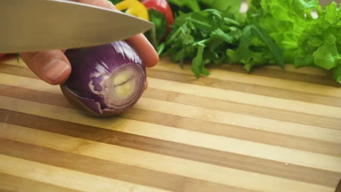 Shot of man chef cutting bow on chopping wooden board Stock Footage 88075657