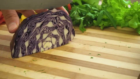 Shot of man chef cutting cabbage on chopping wooden board Stock Footage 87951252