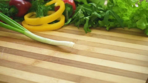 Shot of man chef cutting greens on chopping wooden board Stock Footage 87808636