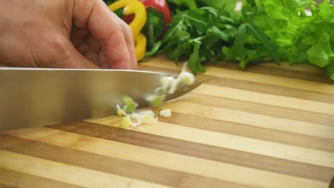 Shot of man chef cutting greens on chopping wooden board Stock Footage 87948485