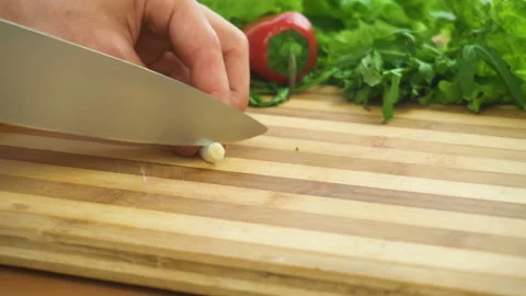 Shot of man chef cutting greens on chopping wooden board Stock Footage 88078554