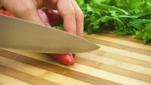 Shot of man chef cutting pepper on chopping wooden board Stock Footage 87817895
