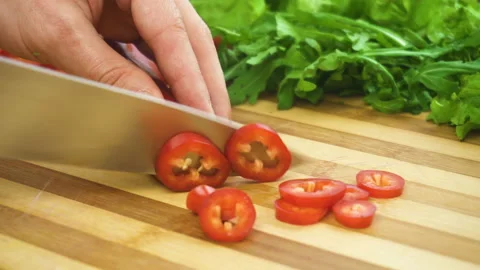 Shot of man chef cutting pepper on chopping wooden board Stock Footage 87952863