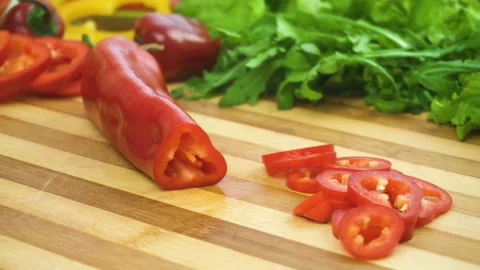 Shot of man chef cutting pepper on chopping wooden board Stock Footage 88081322
