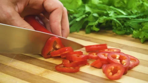 Shot of man chef cutting pepper on chopping wooden board Stock Footage 88082915