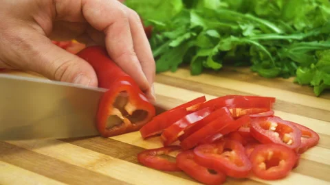 Shot of man chef cutting pepper on chopping wooden board Stock Footage 88168011