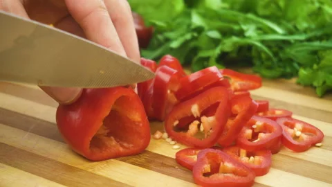 Shot of man chef cutting pepper on chopping wooden board Stock Footage 88176543