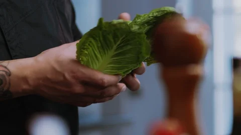 Shot of man chef hold cook shares the cabbage cutting salad vegetarian Stock Footage 100303223