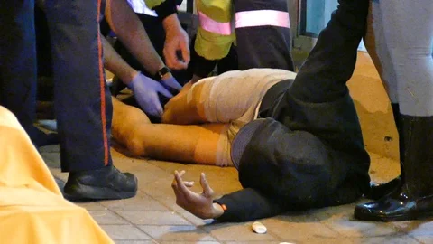 Shot man screaming in pain while paramedics help him - 24fps 1080p Video stock 91562049