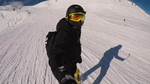 Shot of man snowboarder shooting himself on a gopro in the mountains camera Stock Footage 124064591