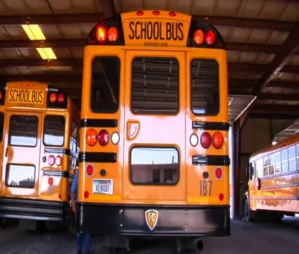 Shot of man walking behind parked schoolbus Stock Footage 21623928