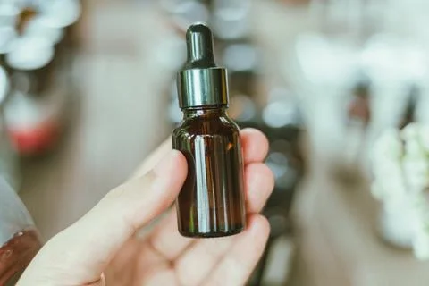 Shot of mature perfumer adding extra essential oil Stock Photos