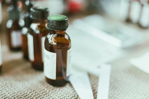 Shot of mature perfumer adding extra essential oil Stock Photos