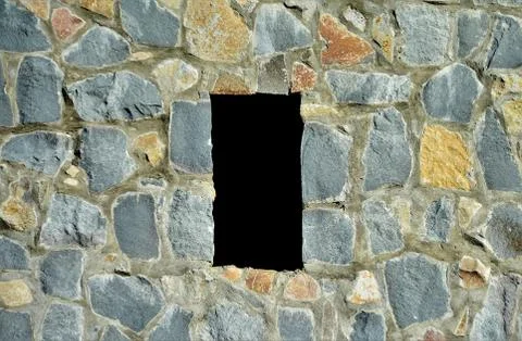 Shot of a medieval stone wall with rectangle hole 스톡 사진