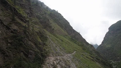 Shot moving down from Himalayan mountain slope to river below. Stock Footage 86758277
