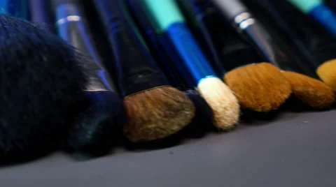 A shot moving in a half circle showing a make up palette with a lot of brushes Stock Footage 68995440
