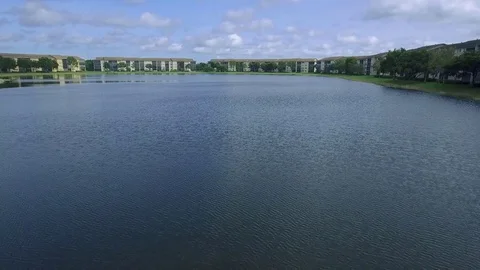 Shot moving in through water and showing apartment buildings in Florida Stock Footage 81594747