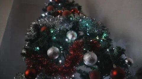 Shot moving towards christmas tree with silver and red decorations on a slider Stock Footage 101761795