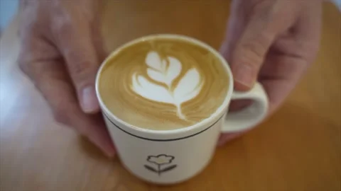 A shot of my firend serving me a hot cup of latte Stock Footage 210167866
