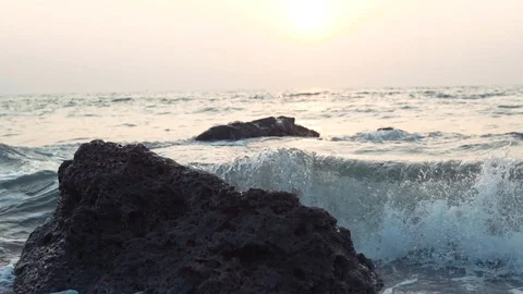 Shot of ocean waves and cliff - waves washing up on a rock in sea Stock Footage