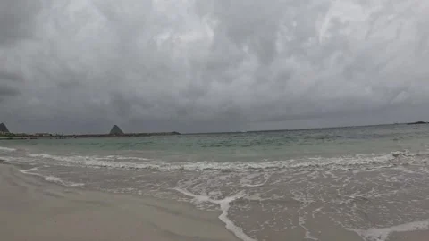 Shot of ocean waves and foam at Bleik Beach with Bleiksoya island Norway Vídeo Stock 343130708