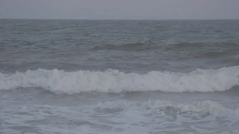 A shot of Ocean waves at the beach on a sunset cloudy summer day Stock Footage 167389897