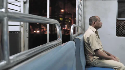 A shot of an old man sitting in a moving local or suburban train in the night, Vidéo 140108974