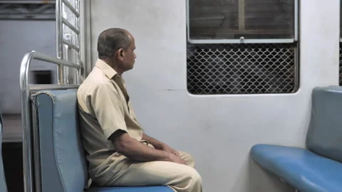A shot of a old man sitting in a moving local or suburban train in the night Stock Footage 140109567