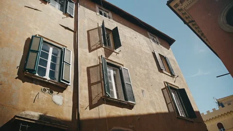 A shot of a older building with windows open to the allow the sun light in. Stock Footage 328735917