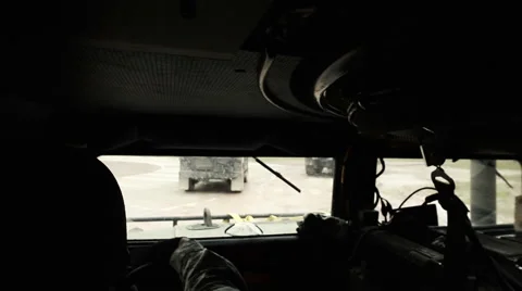 Shot over the driver's shoulder while waiting in a Humvee. Vídeo Stock 52702393