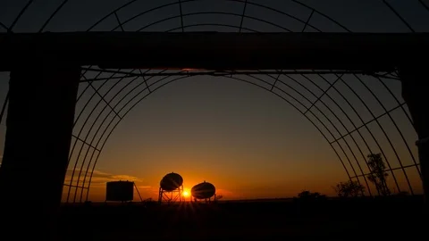 Shot panning forward through a gridded tunnel, sunsrise Stock Footage 99288085
