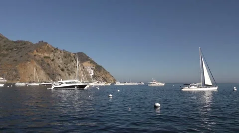 Shot pans as sways gently with the waves showing the moorings Stock Footage 67956807