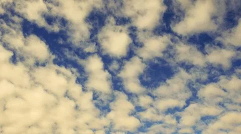 Shot of patterned white clouds against a blue sky Stock Photos