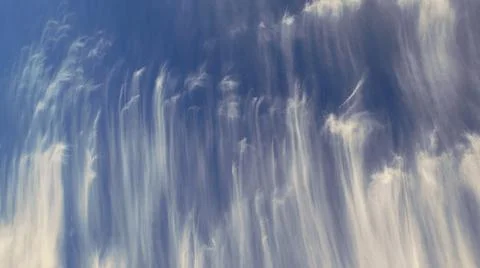 Shot of patterned white clouds against a blue sky Stock Photos