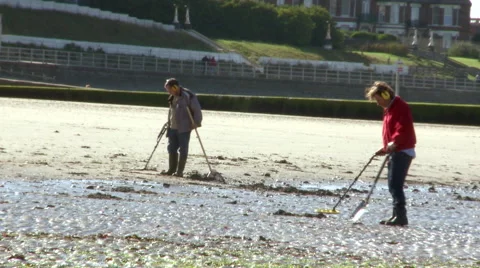 Shot of people using metal detector on the beach Stock Footage 56151873
