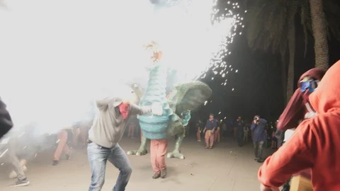 Shot of performers Lighting the fireworks on the Correfoc dragon Stock Footage 100386600