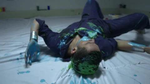 Shot of Performing art of a dancing man bathed in colored paint. Stock Footage 255599554