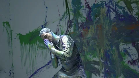 Shot of Performing art of a man dancing bathed in colored paint Stock Footage 255352806